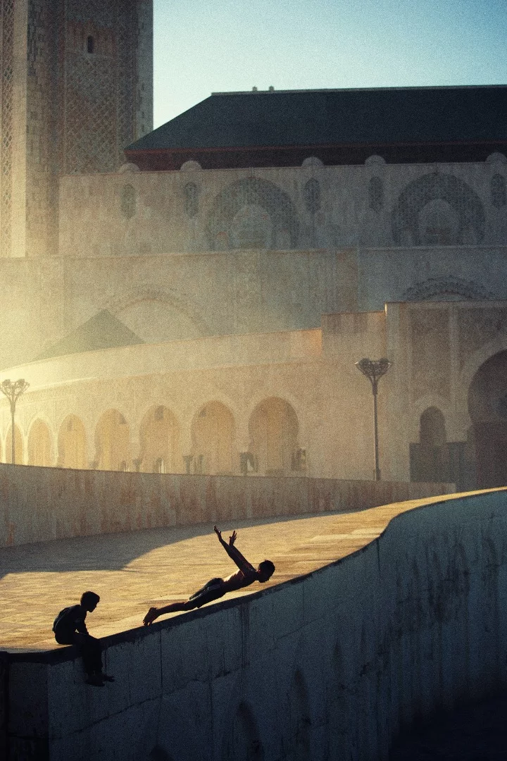 Casablanca , Morocco. A young boy is jumping into the Atlantic Ocean on a step of Mosque Hassan II