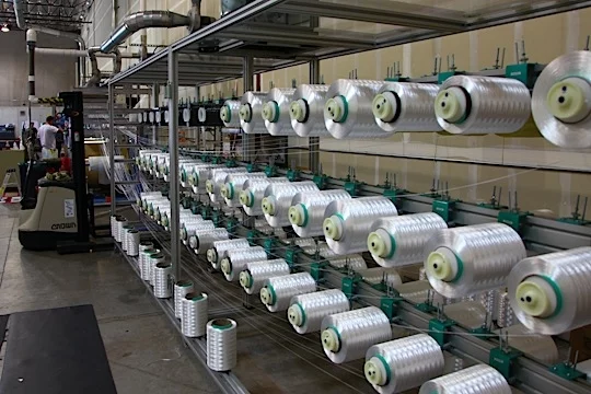 Spools of Aramid, carbon fiber and Dyneema awaiting assembly into Spread Filament Tape