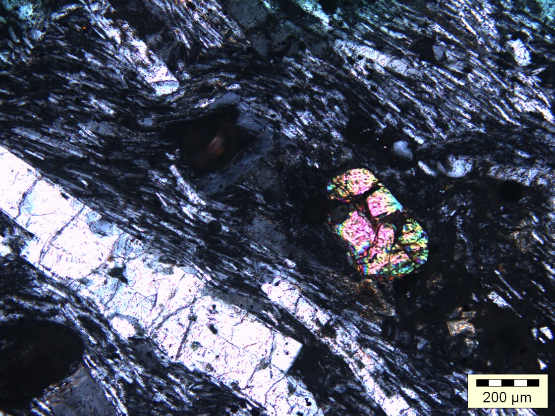 A close-up of a zircon crystal (i.e. the brightly colored grain)