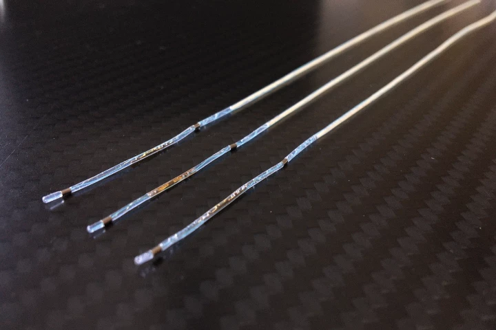 Three of the muscle-stimulating implanted electrodes – these ones are attached to silicone tubes which were used to more easily extract them from test subjects' bodies once the study was completed
