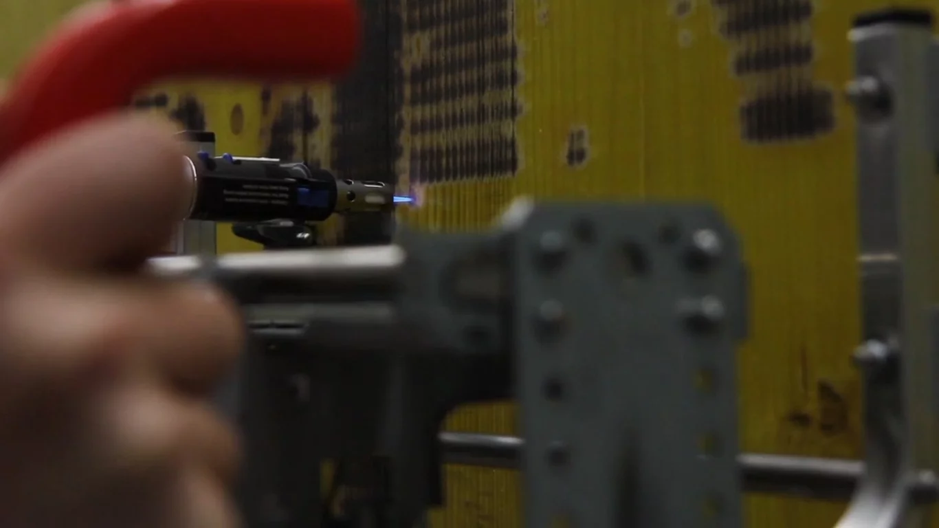 After feeding a black-and-white image through a Processing script and sending the resulting code to the Arduino board, the printer begins to burn line by line as a series of dots