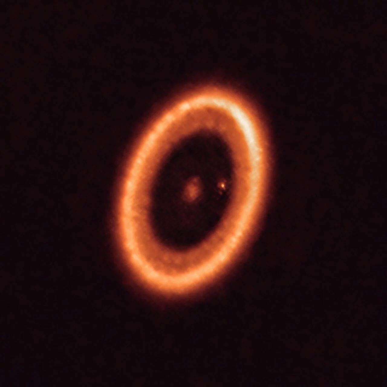 Wide field view of PDS 70 showing the exoplanet PDS 70c as a bright point located inside the massive circumstellar disk