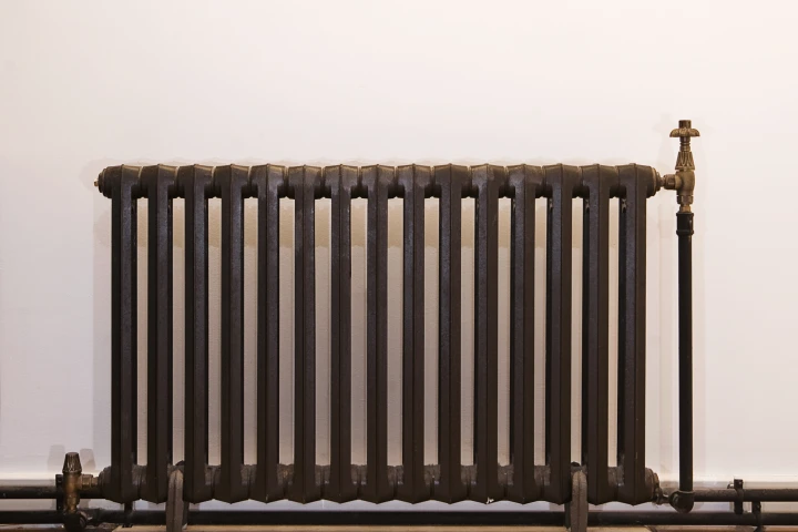 Radiator Labs heavily insulated housings physically cover radiators like this one, trapping heat in the system, and strictly controlling the amount that is let into the room
