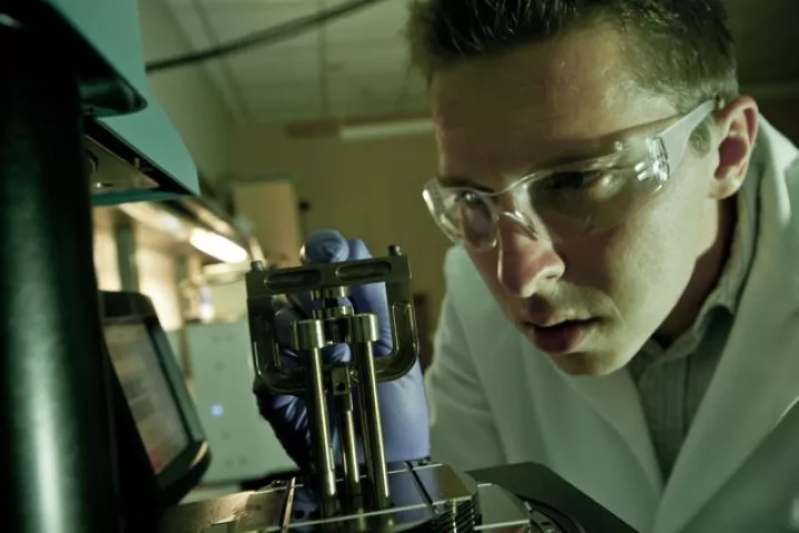 Graduate student Brent Carey, positioning a piece of the nanocomposite material for dynamic mechanical analysis(Photo: Jeff Fitlow/Rice University)