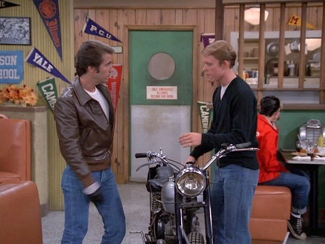 Arthur Fonzarelli (Henry Winkler), the auctioned Triumph and Ritchie Cunningham (Ron Howard) at Arnold's Drive-in.