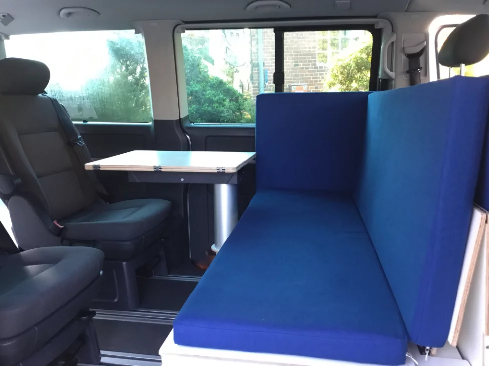 The two rear seats and bench/chaise lounge combine into a front dining area, no need to swivel the cab seats around