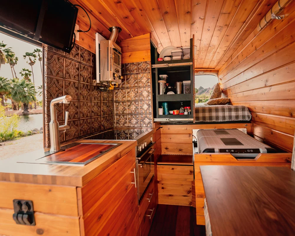 Another space-saving measure, the large Dometic fridge/freezer slides away under the bed when not in use