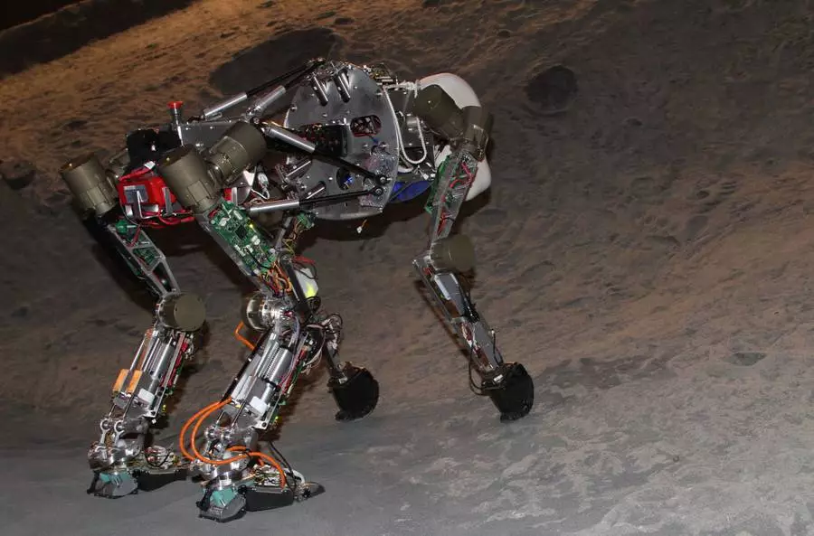 The four-legged iStruct Demonstrator robot in DFKI's artificial crater environment (Photo: Daniel Kühn, DFKI GmbH)