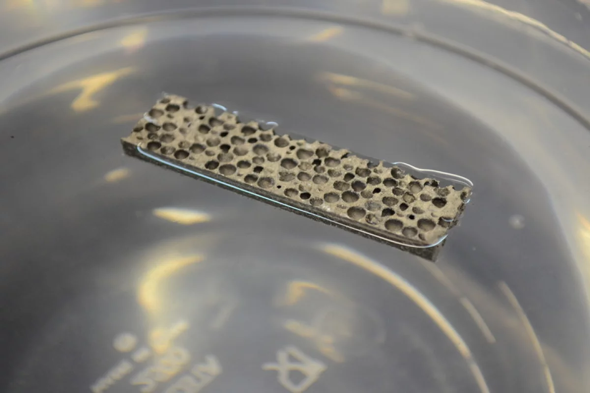 The new lightweight metal matrix foam floating in a beaker of water
