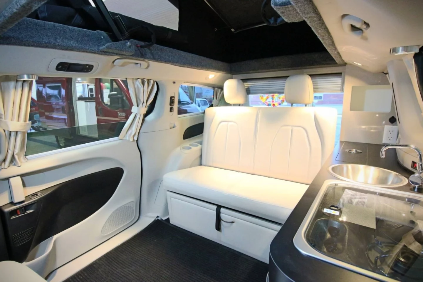 There's no mention of a pop-up roof bed available on the Illusion Hybrid, so it seems the pop-top is there just to provide more headroom