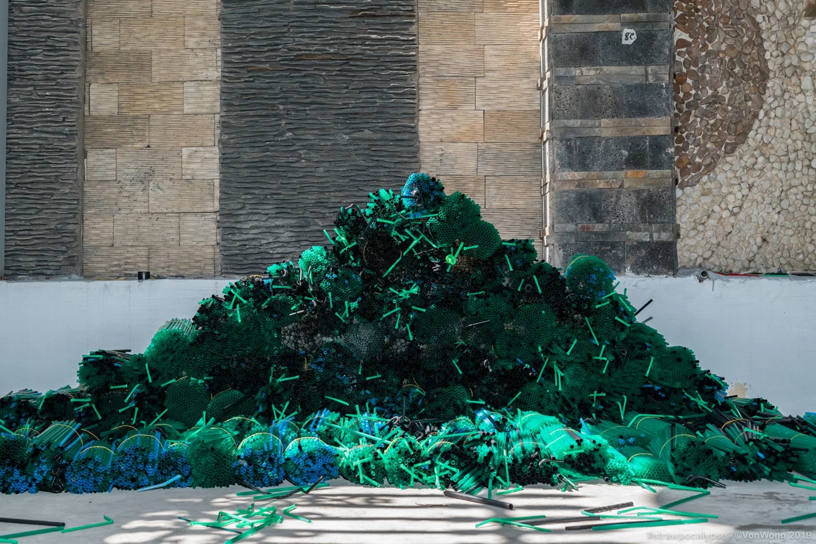 Organized plastic straws during construction of the Strawpocalypse installation
