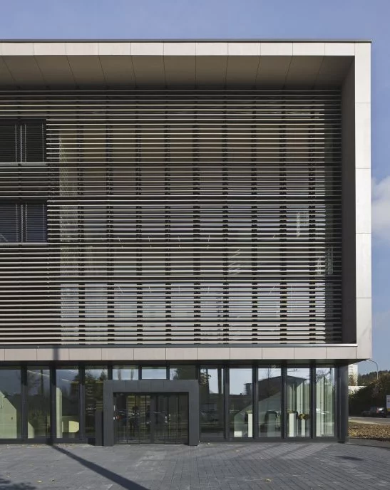 The sleek rows of windows in the building's recessed oblong front combine with the wood finish to create the impression of a piece of 1970s consumer electronics (Photo: Buckhardt+Partner)