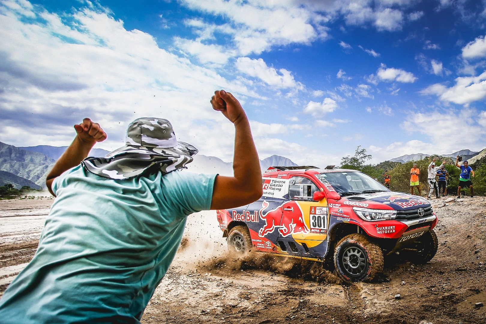 Spectators cheer on a Toyota team close to the completion of the 795-km Stage 10