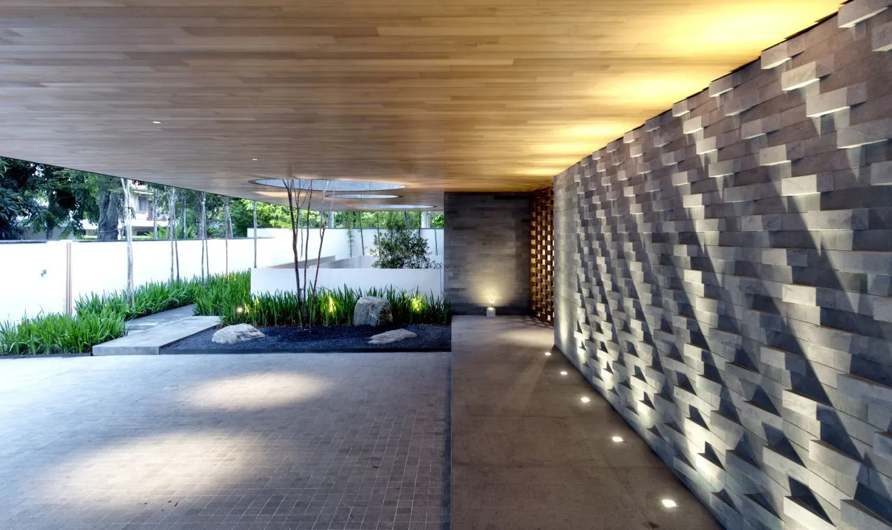 The ground floor residence contains a library, patio, water feature, kitchen, and guest room (Photo: Bryan van der Beek and Edward Hendricks)