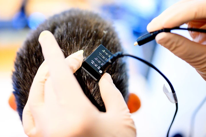 Researchers from UC Berkeley and UC San Francisco connect their subject Ann's brain implant to the voice synthesizer computer