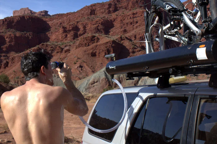 The Road Shower uses the Sun to heat its matte-black water tank