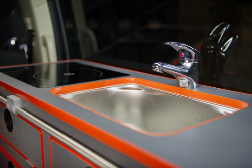 The kitchen includes a sink and induction hobs powered with help from solar panels