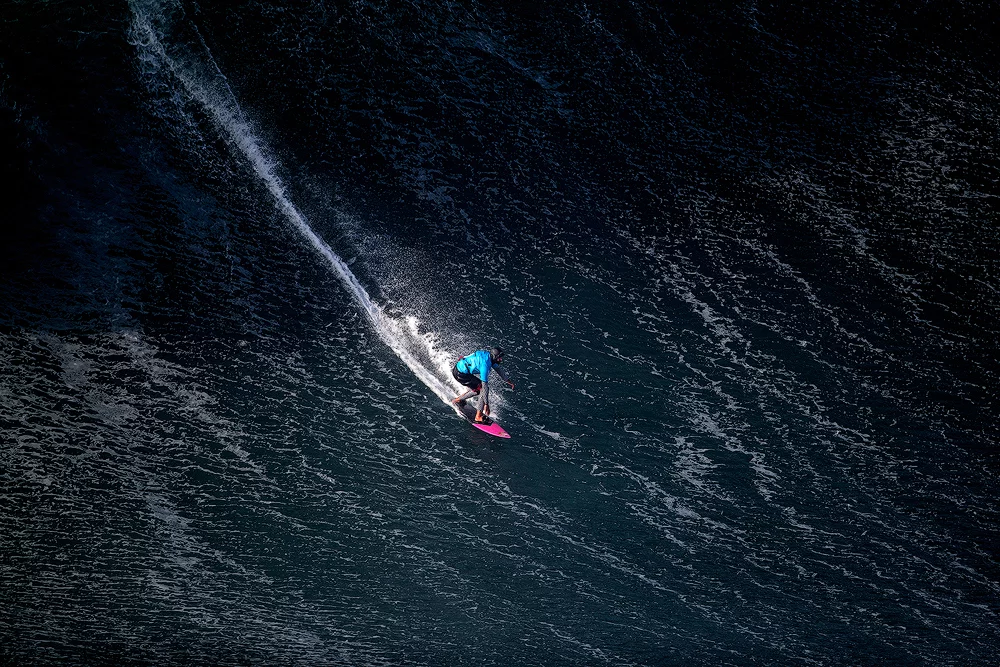 Nominee, Professional, Open Theme. The shadow of a giant wave looms over this surfer in Portugal