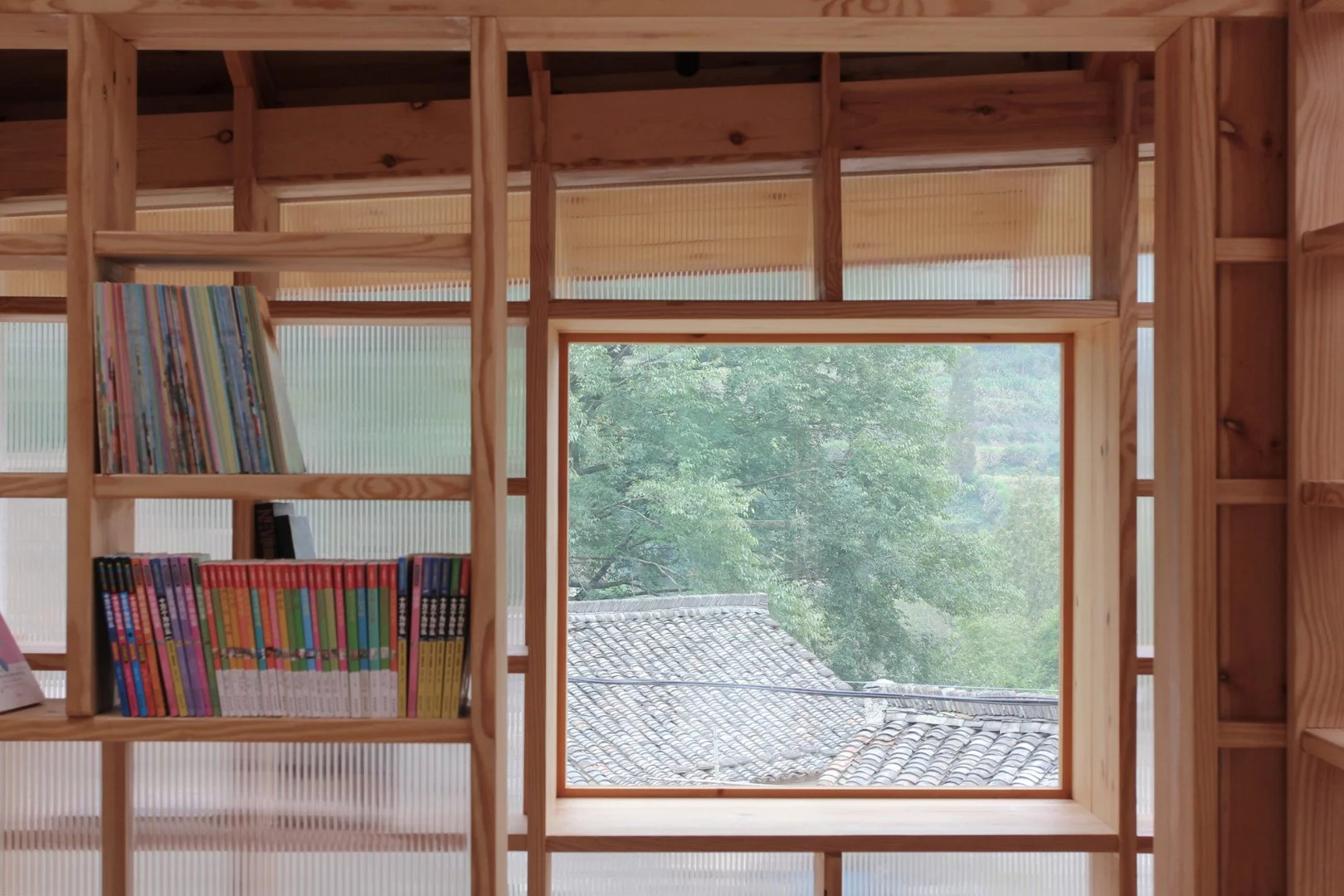 The raised building is located near to a children's playground and parents can sit, book in hand, while keeping an eye on their kids through the windows
