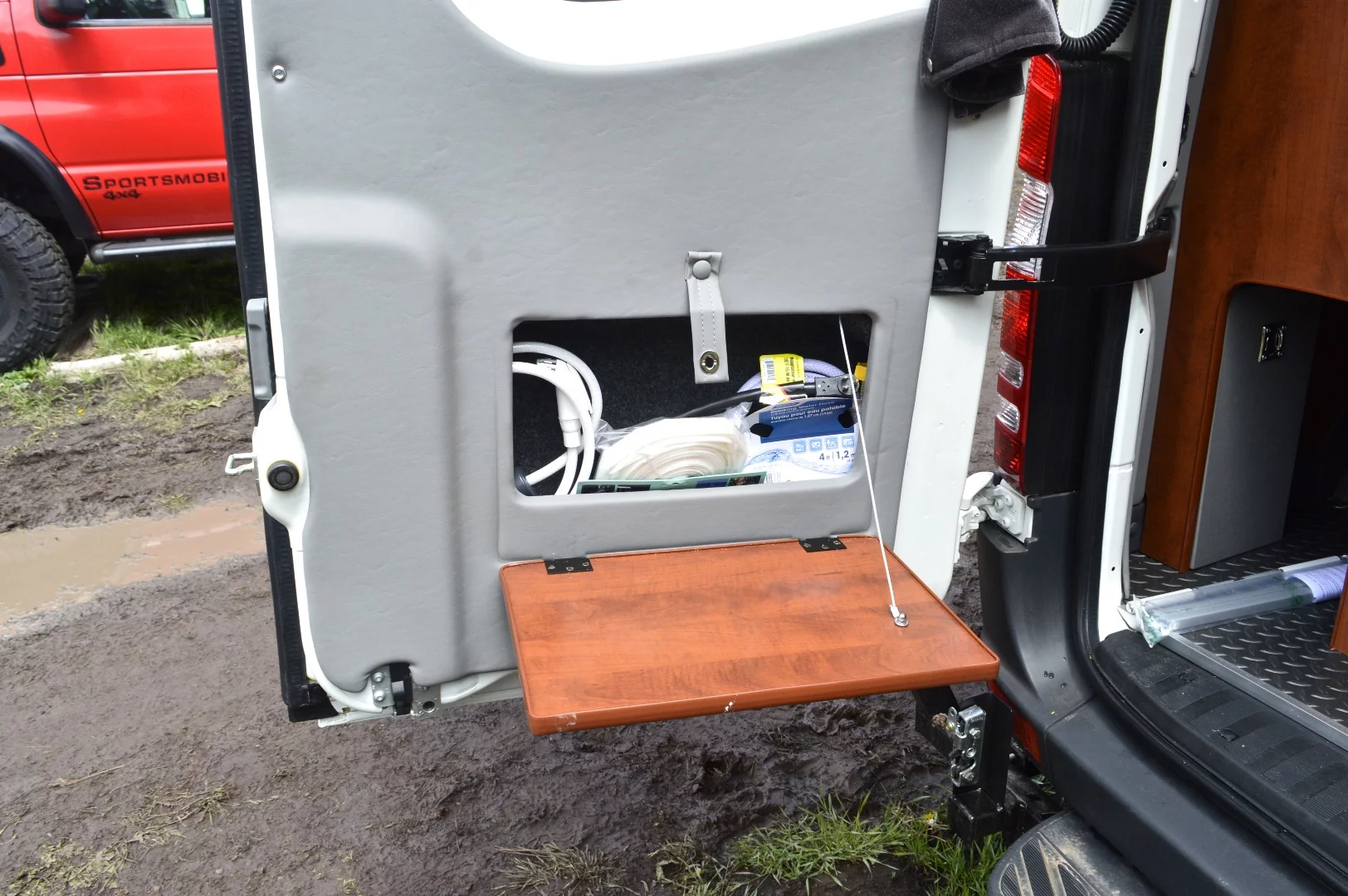 An outdoor shower pops out of a compartment on the rear door