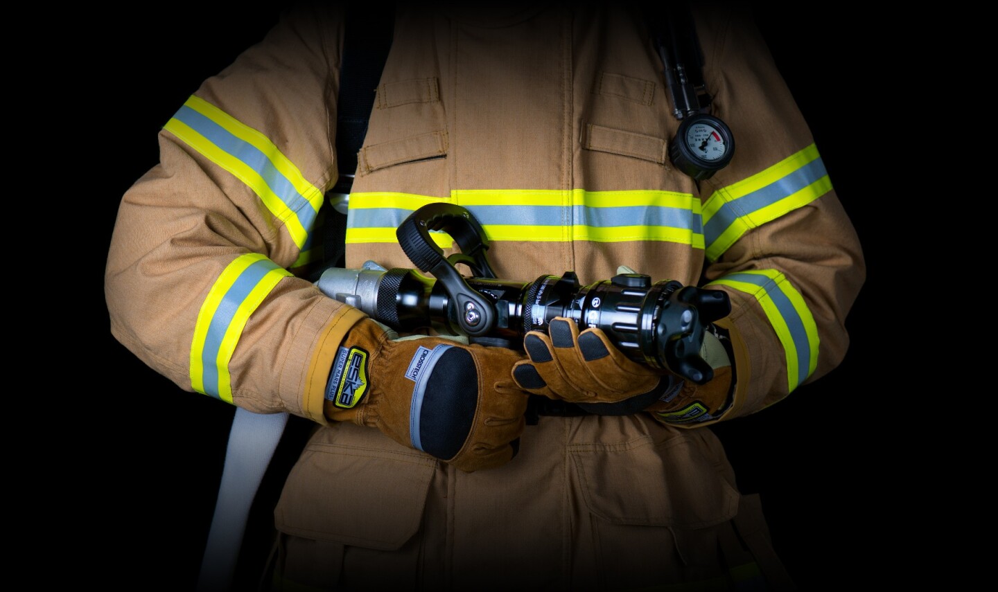 The FLAIM system uses a Vive Tracker on the end of a firehose, which tracks its movements in a virtual world and generates haptic feedback to simulate the force of the water jet