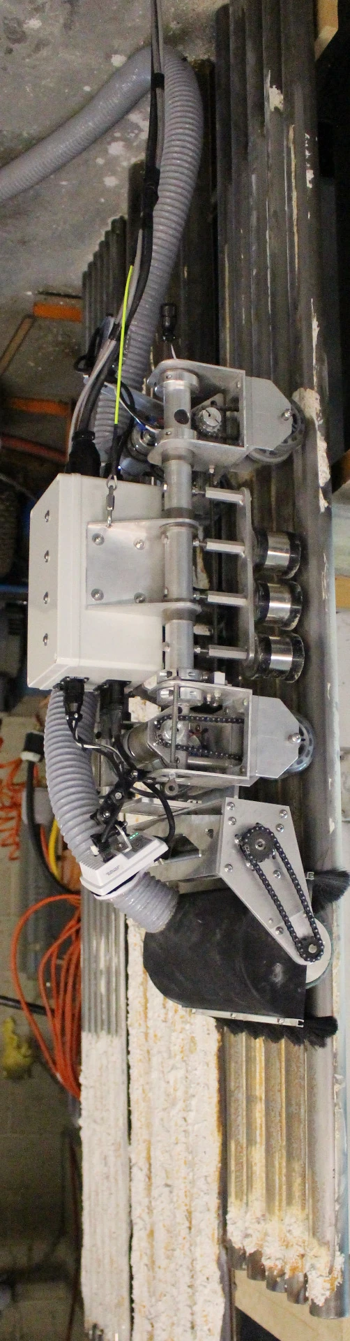 The boiler pipe cleaning robot has front and rear cameras to aid navigation and visual inspection