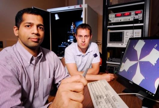 Raghunath Murali (left) and graduate student Kevin Brenner are shown with a test station used to study the properties of graphene. Pic credit: Georgia Tech/Gary Meek