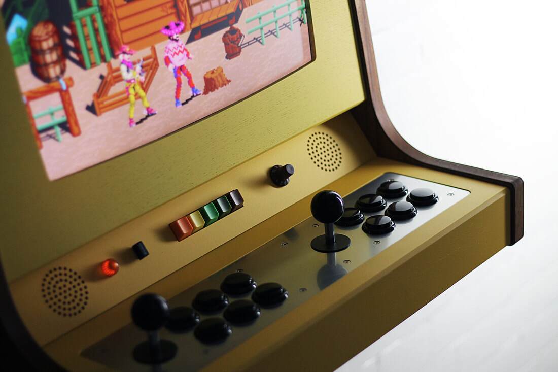 The OriginX's handcrafted walnut enclosure with an aluminum control panel and bright yellow facade hangs on the wall