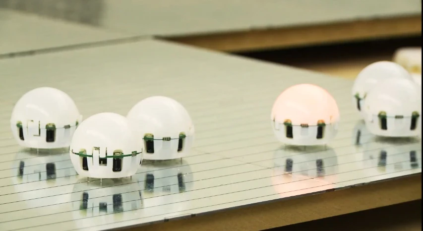 Egg-like Droplet swarm robots communicate via IR, and move with vibrating motors