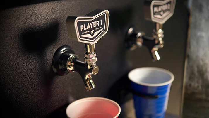 The Beercade works like any other arcade fighting game, except the standard coin slots have been replaced with a pair of spigots, drip trays, and motion sensors