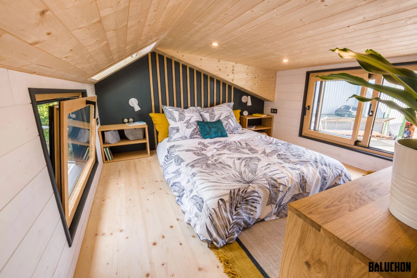 The Gaïa Tiny House's main bedroom includes a double bed and some storage space
