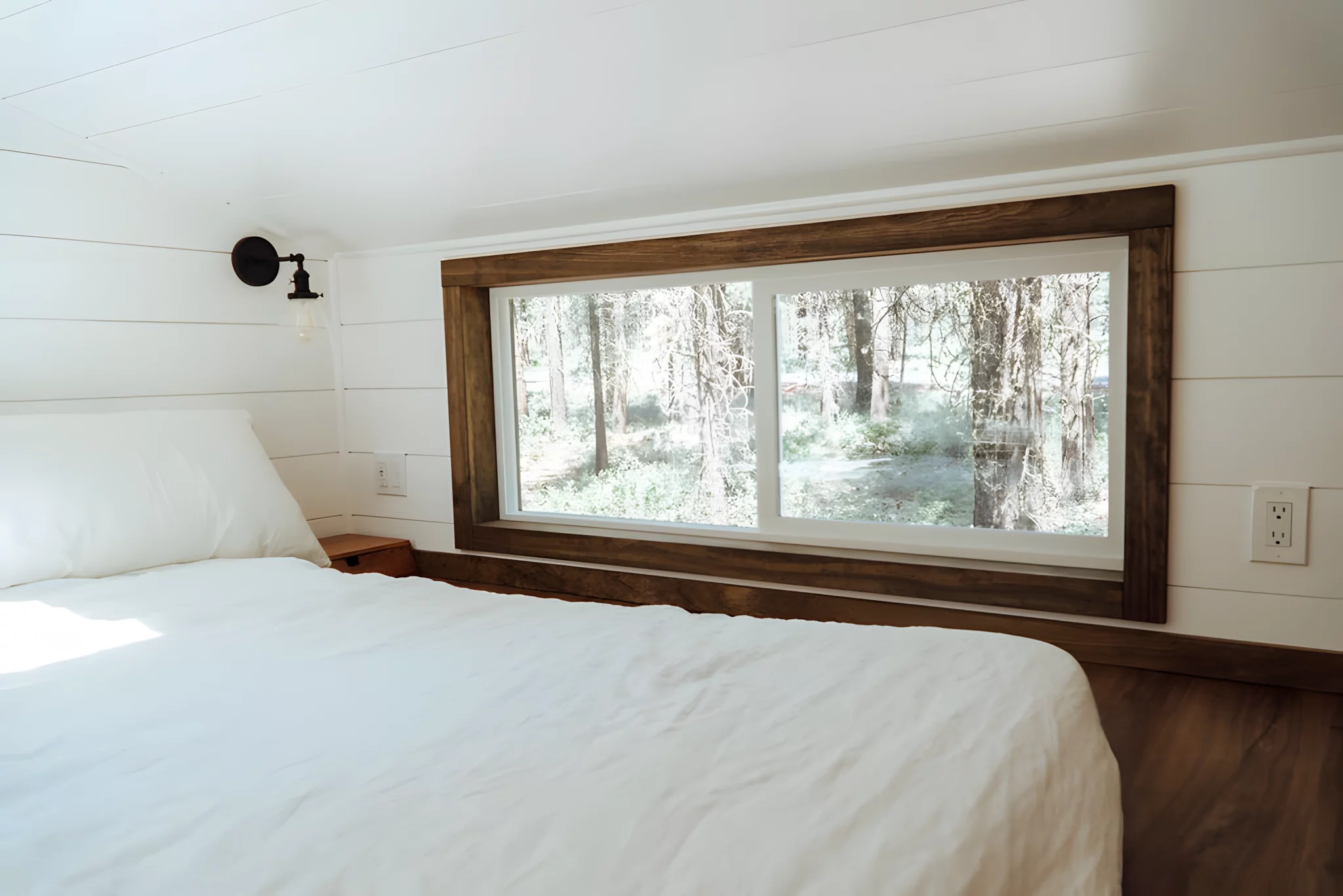 The Olympic's bedroom is a typical tiny house-style loft model with a low ceiling