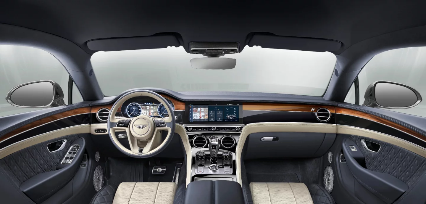The widescreen display in the Continental GT folds away to reveal a simple wood trim or trio of analog dials