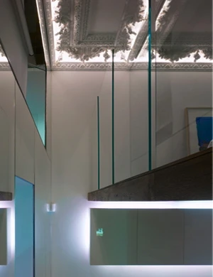 Frosted glass walls and balconies permits natural light to filter through to the elevated spaces