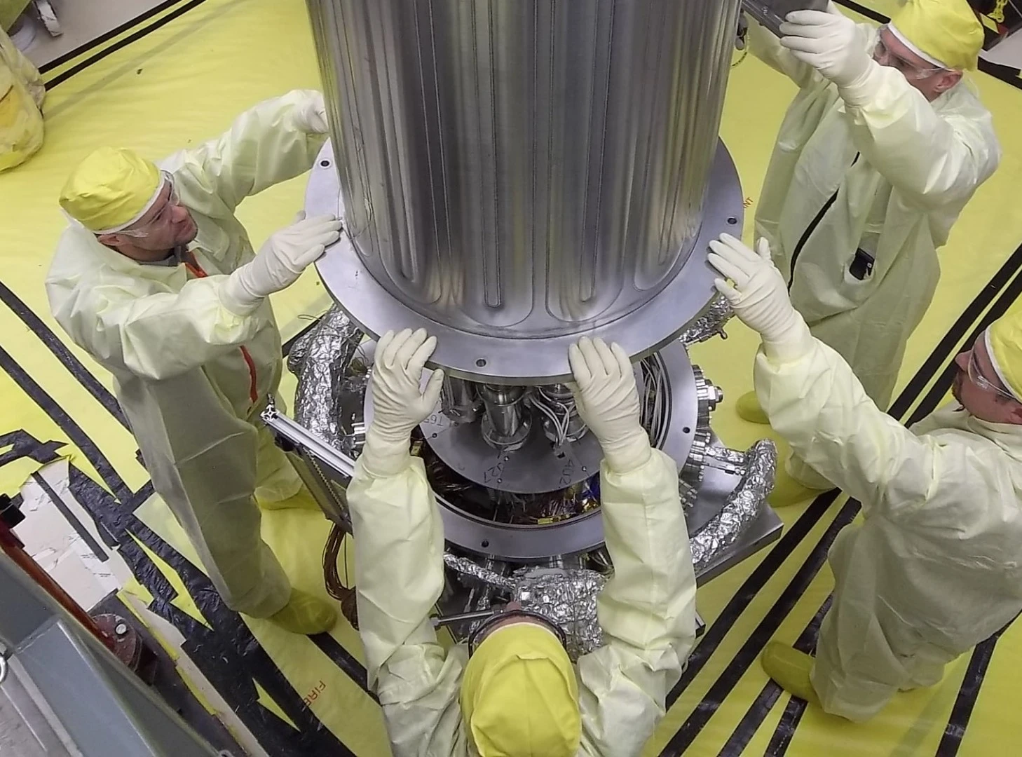 NASA and NNSA engineers lower the wall of the vacuum chamber around the Kilowatt Reactor Using Stirling TechnologY (KRUSTY system)