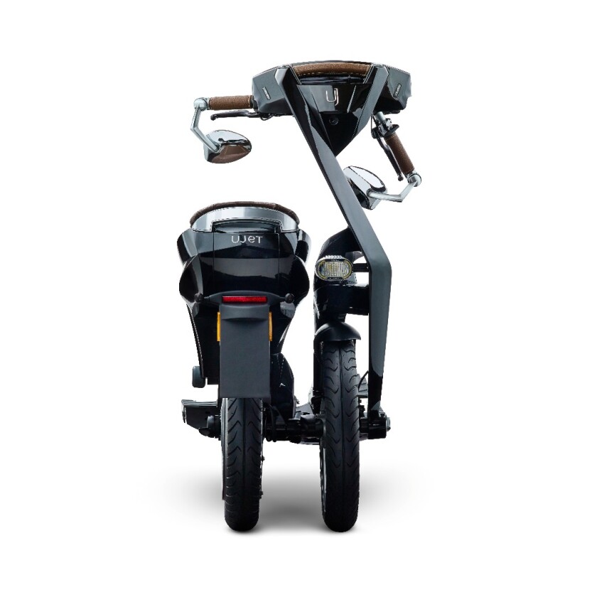The scooter itself folds up and rolls like a trolley