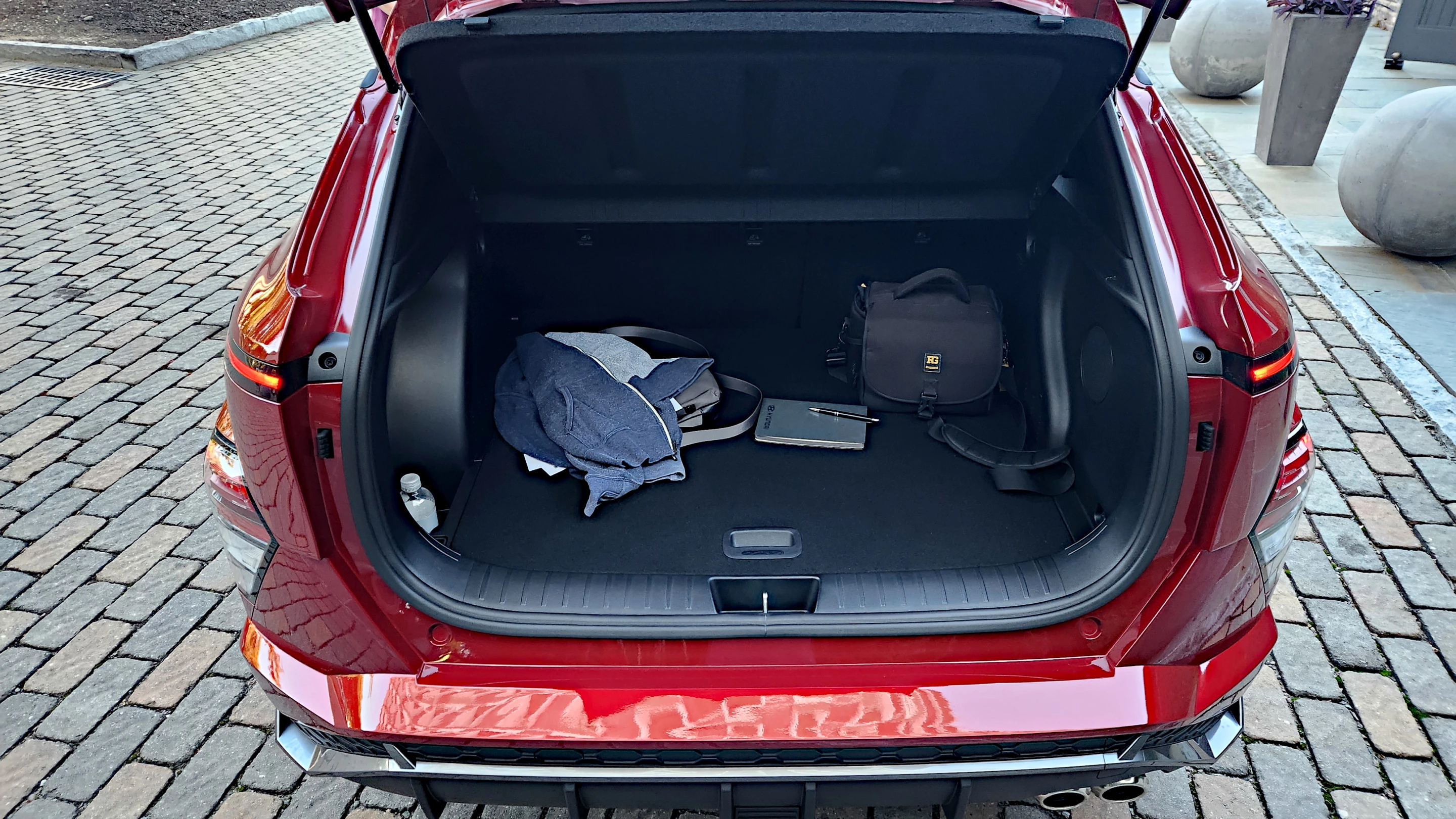 In the cargo space, Hyundai made a little more room in the 2024 Kona and a slot for the removable cover to be stowed in