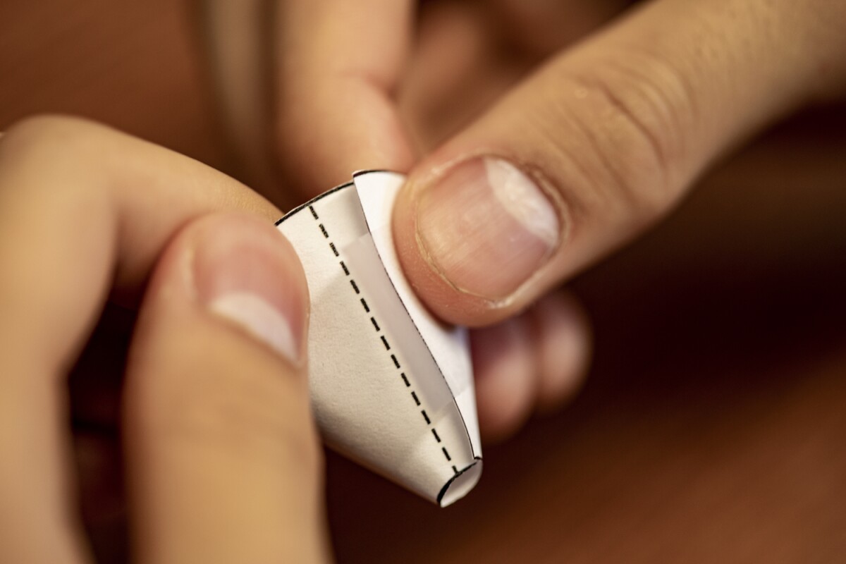 The system uses a regular piece of paper cut and folded into a funnel to guide sound waves in and out of the ear canal