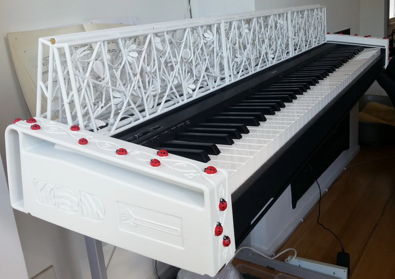 An army of ladybugs marches up and over the side of the keyboard