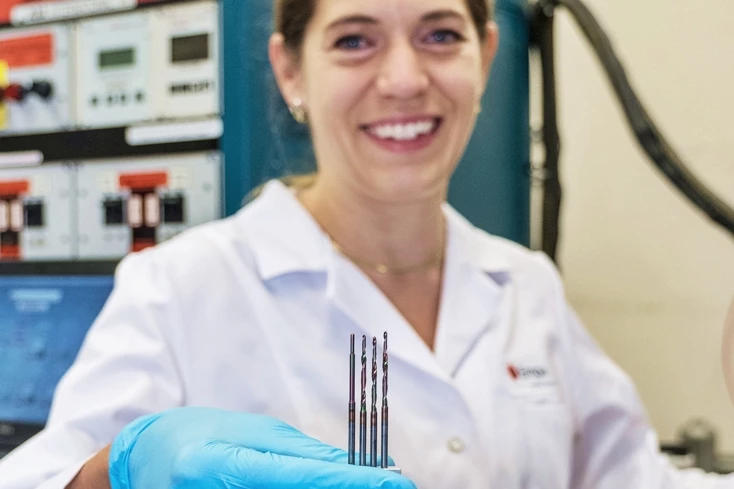 Dr. Kerstin Thorwarth, who worked with a colleague to develop the smart drill technology, displays some of the electrified bits