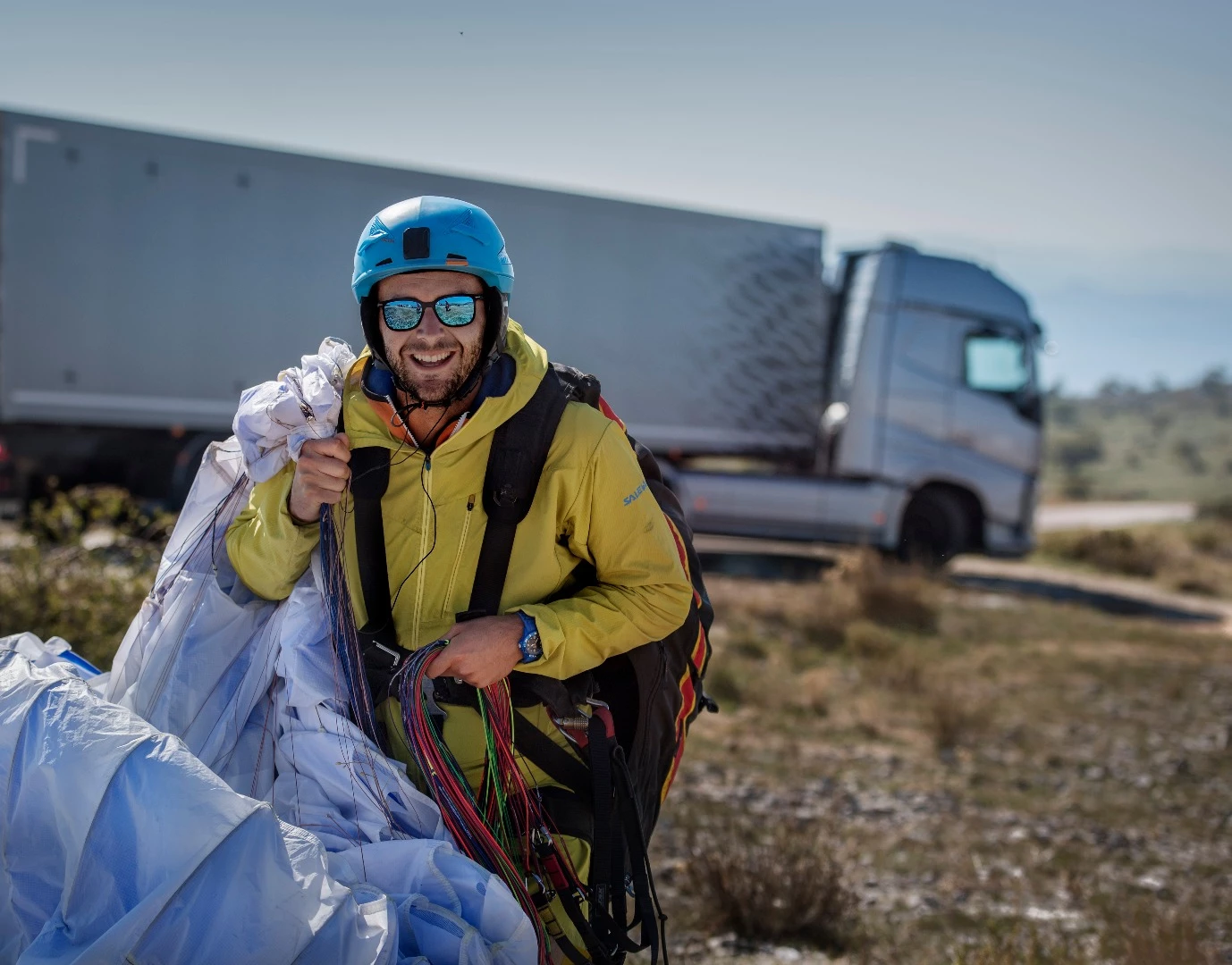 The paraglider looking safe and well after his ride on the back of a Volvo truck