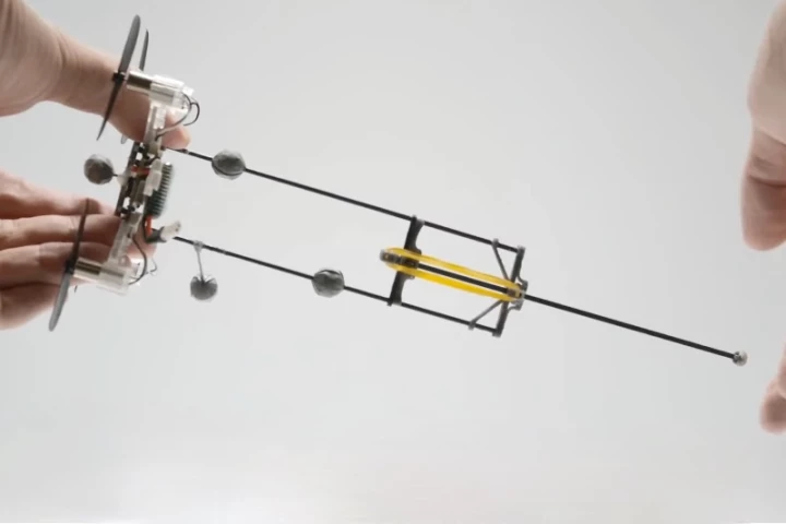 The Hopcopter drone, held sideways in this shot