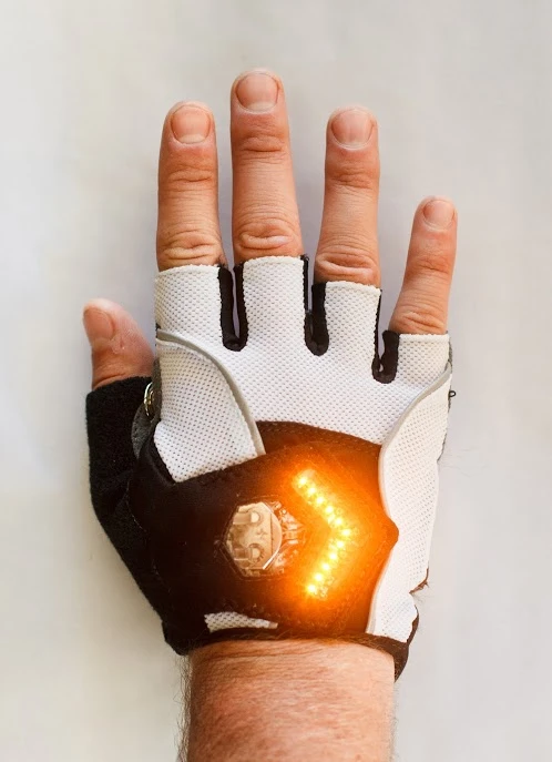 Each glove has an array of LEDs embedded in its back, which are powered by two onboard coin cell batteries