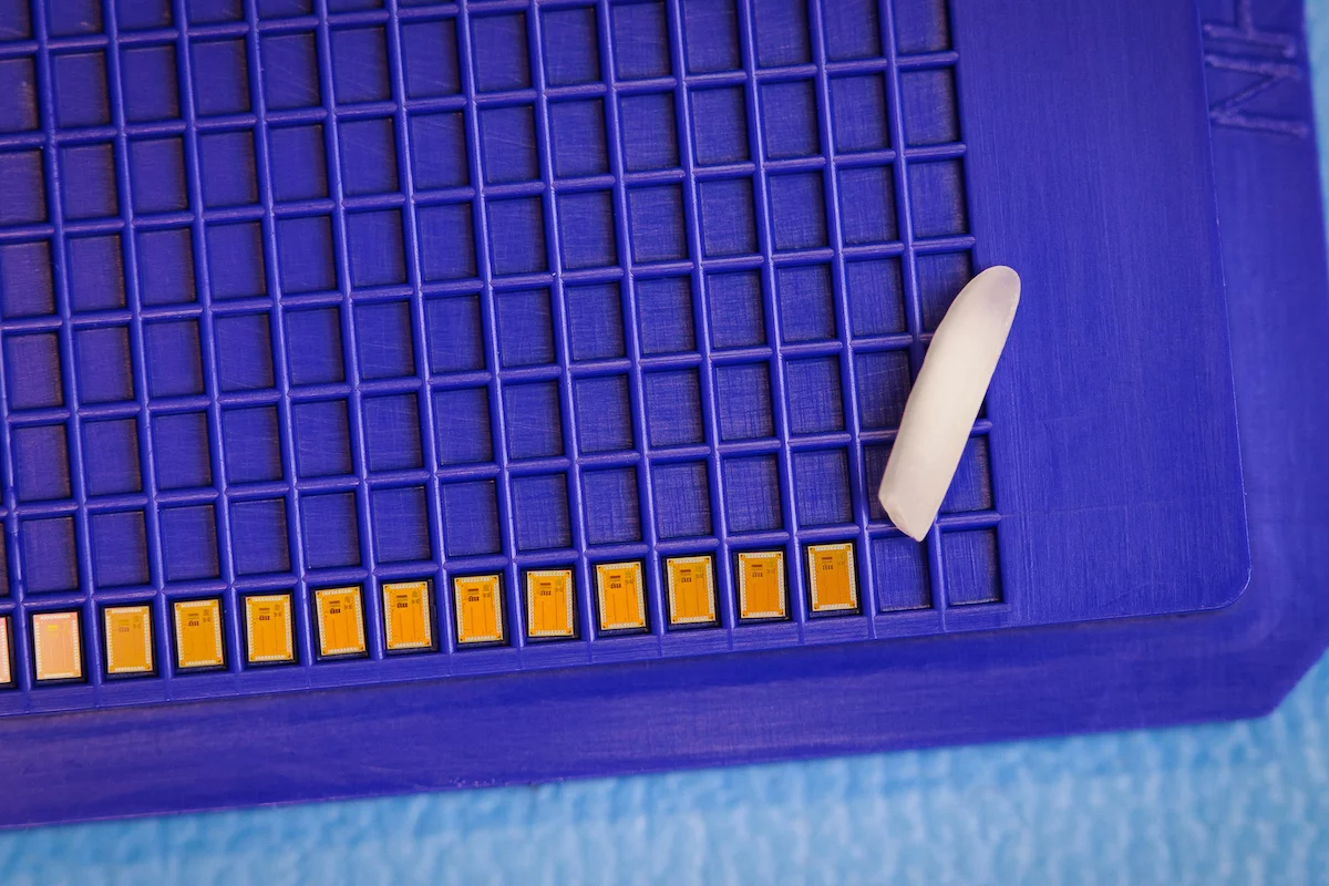 A series of the Wi-Fi chips, with a grain of rice for scale