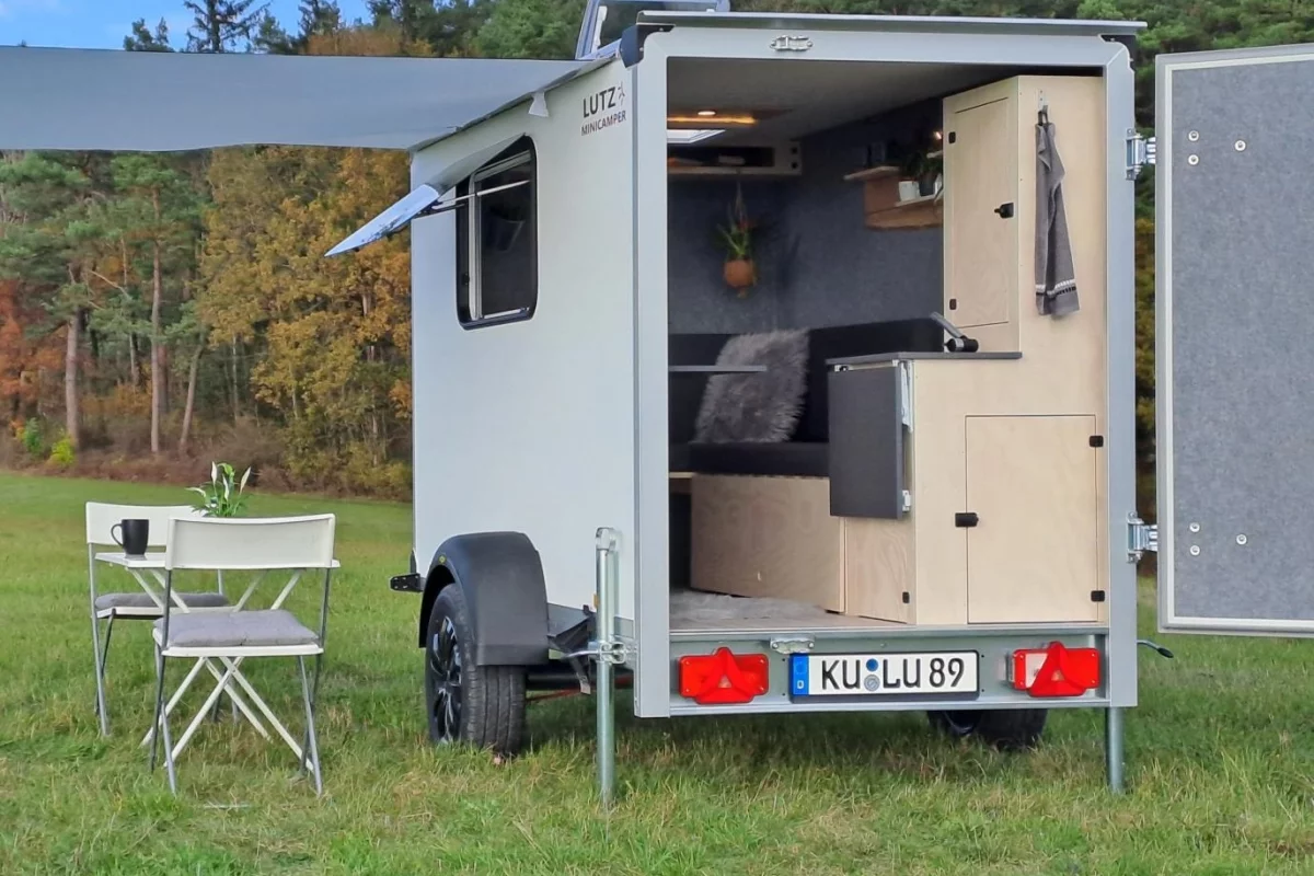 White cargo box outside, homey tiny lodge inside
