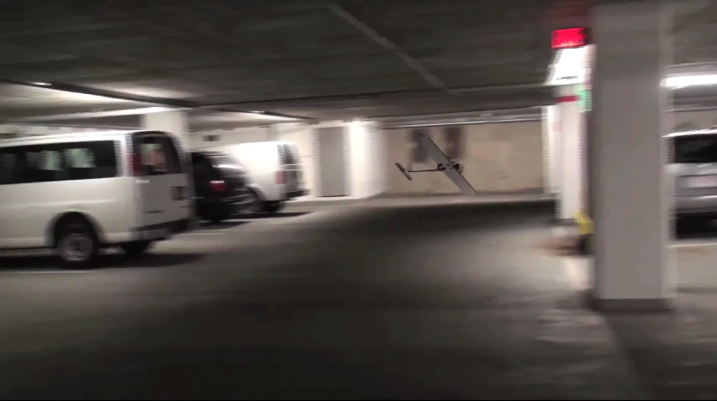 The UAV maneuvers through a multi-story car park