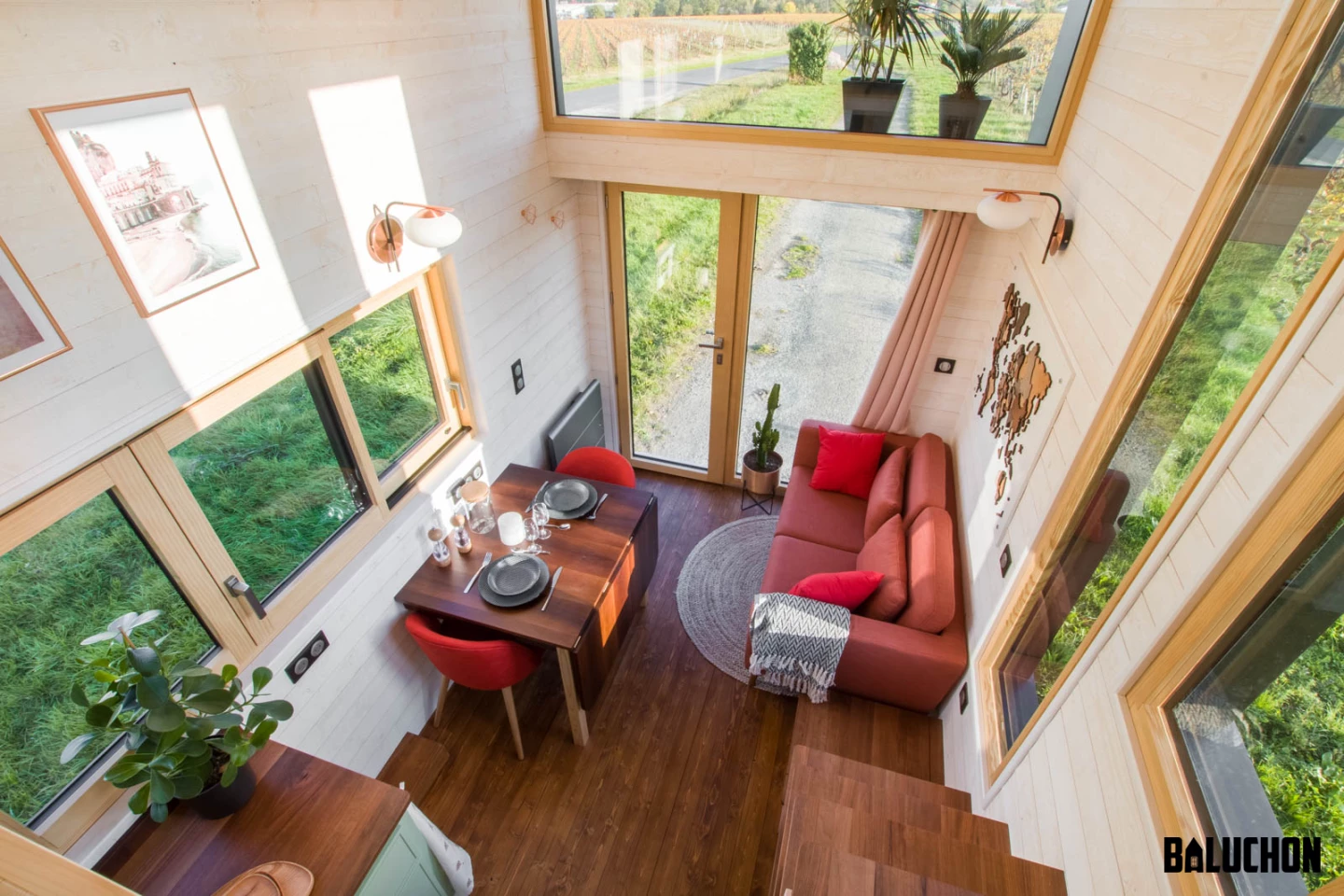 The Ala Köl's living room features a high ceiling and is light-filled thanks to all its glazing, flattering the snug space