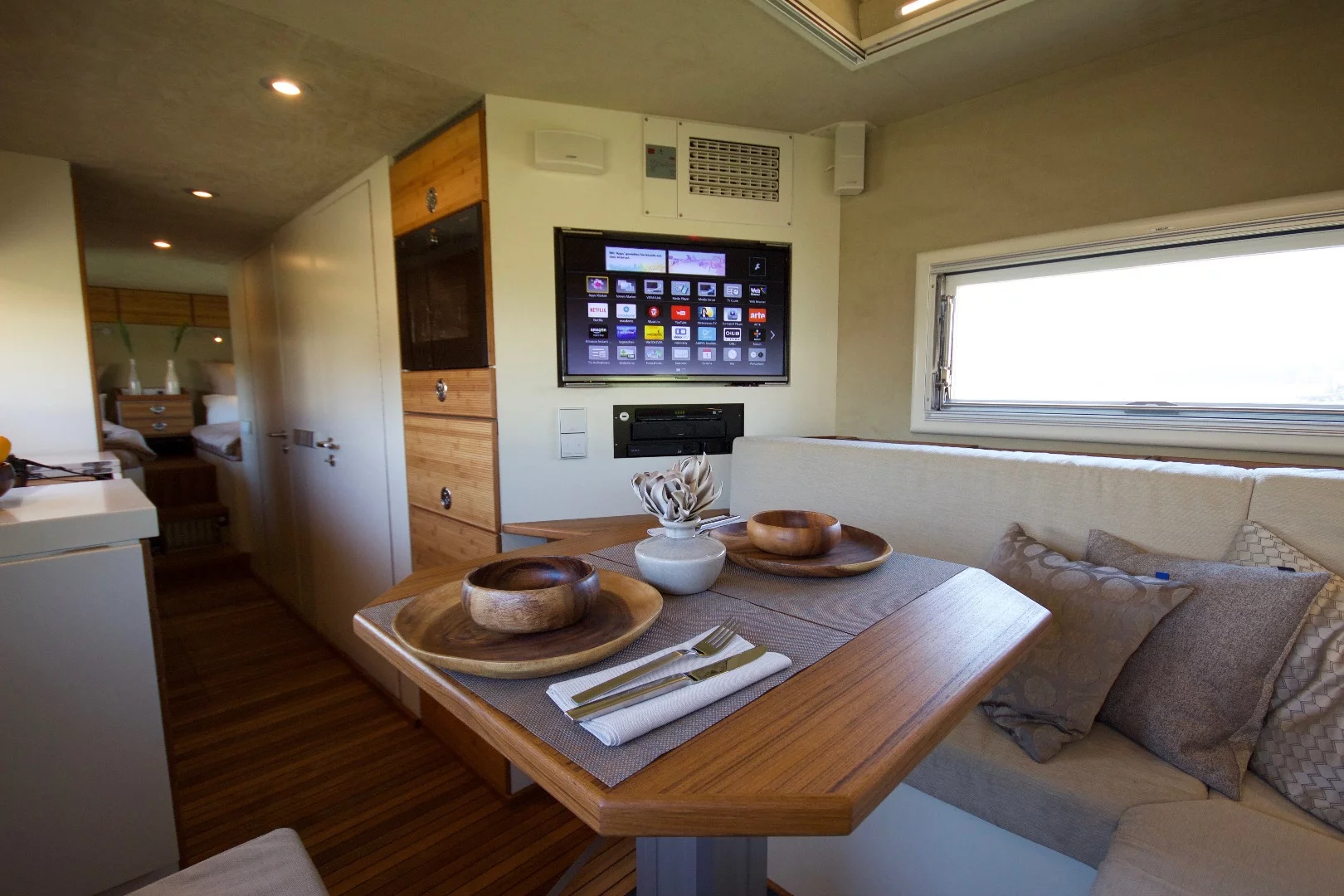 The dining/lounge includes seating for four to five people and an entertainment center. The sofa and table convert to a bed