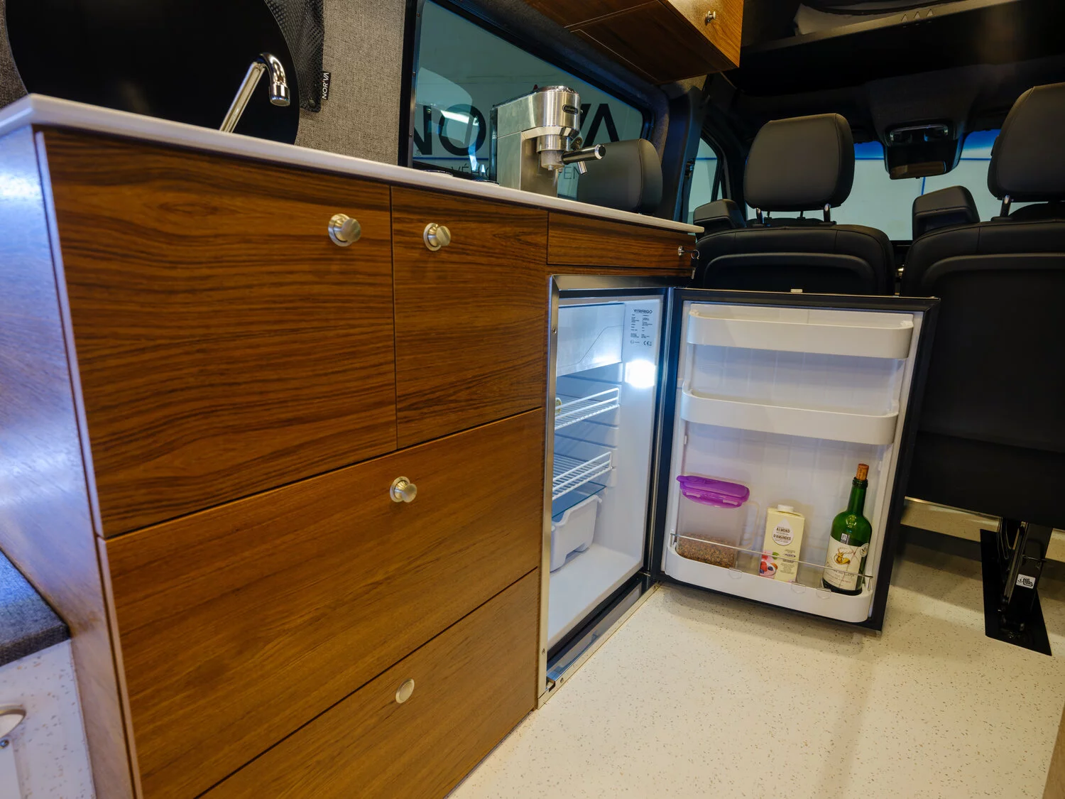 The stainless steel fridge/freezer sits below the sink block counter