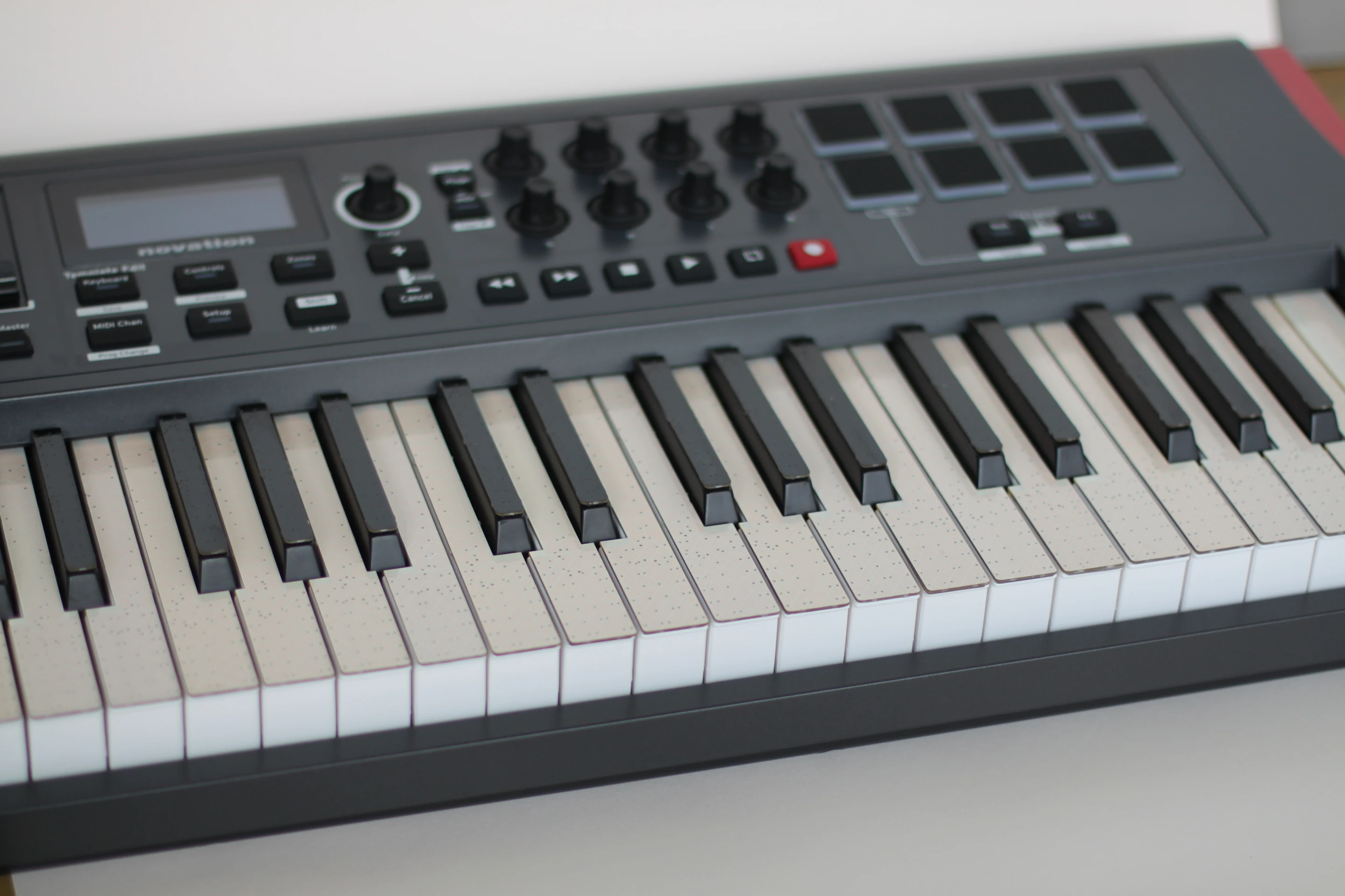 Peel-and-stick capacitive touch sensor overlays attach to the surface each white and black key on any standard width keyboard, covering the entire playing surface of the key